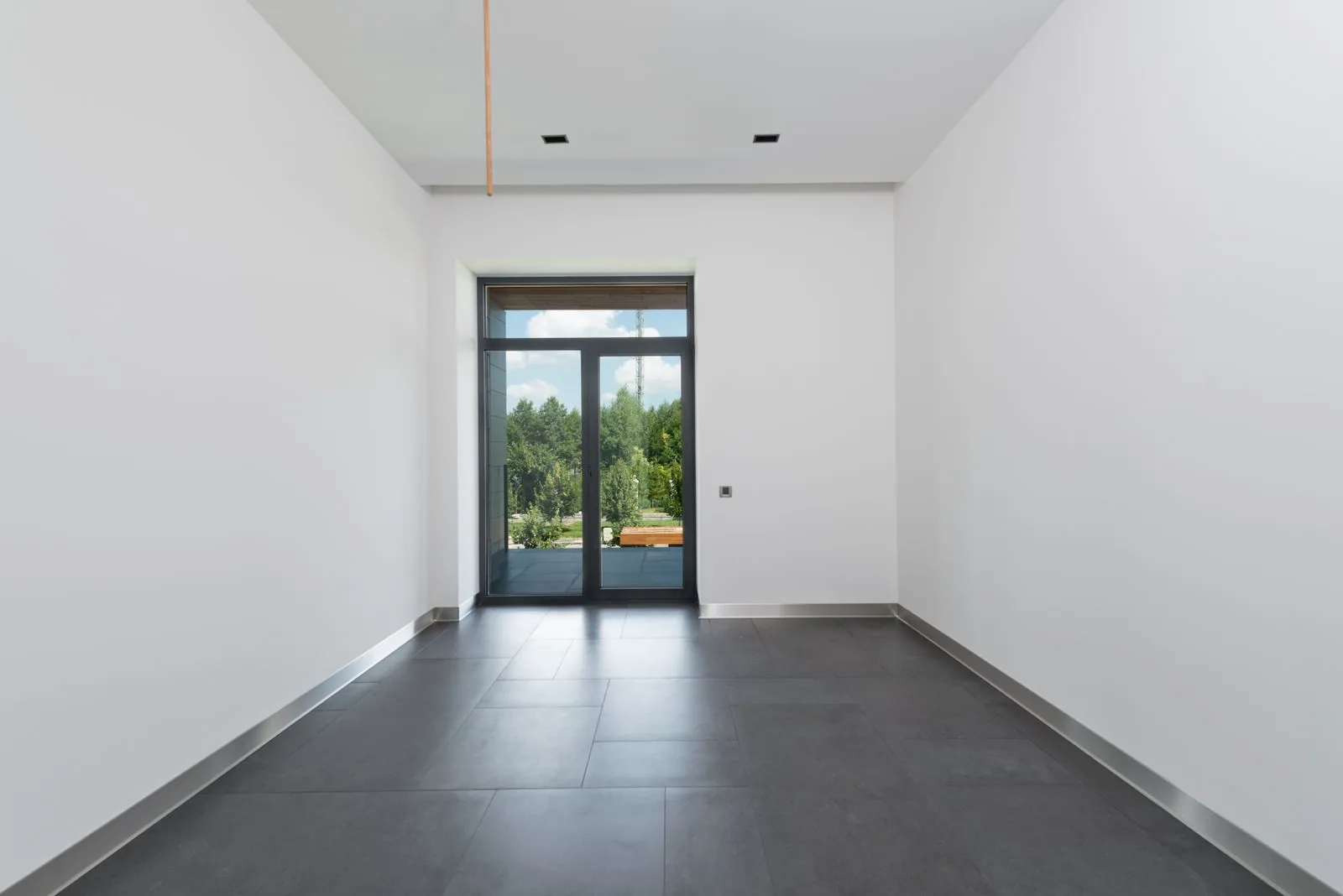 Clear, uncluttered corridor leading to an exit door