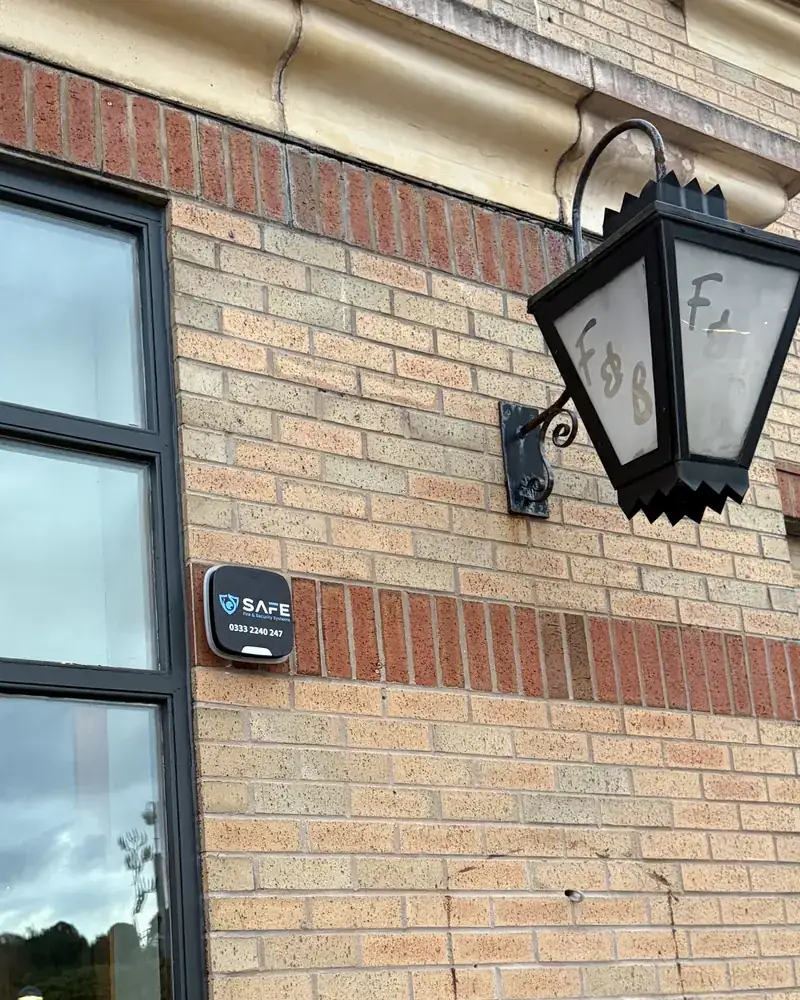 SAFE intruder alarm bell box fitted to the wall of an empty commercial building